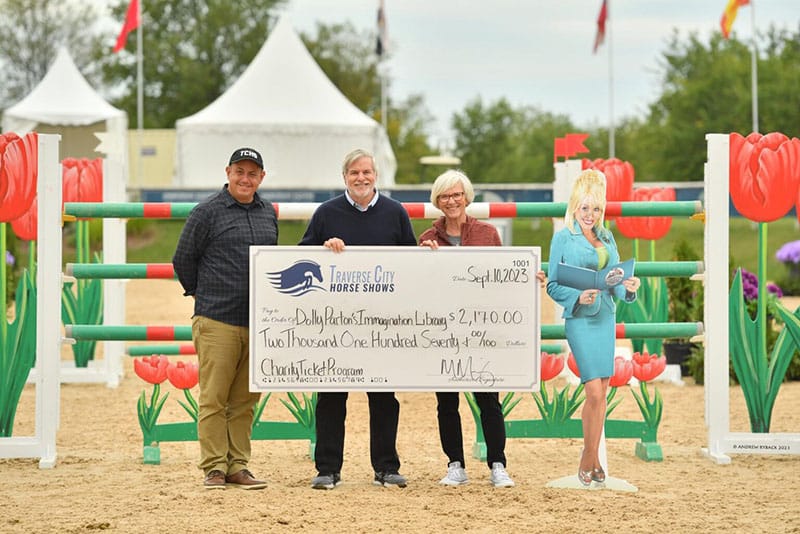 Proceeds from ticket sales on Sunday were presented to Dolly Parton’s Imagination Library GTR in the amount of $2,170 as part of the Traverse City Horse Shows Charity Ticket Program. Bob Robbins and Jan Engle of the Rotary Club of Traverse Bay Sunrise accepted the donation for collaborative Books from Birth initiative. Photo © Andrew Ryback Photography